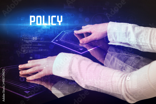 Hand touching digital table with POLICY inscription, new age security concept