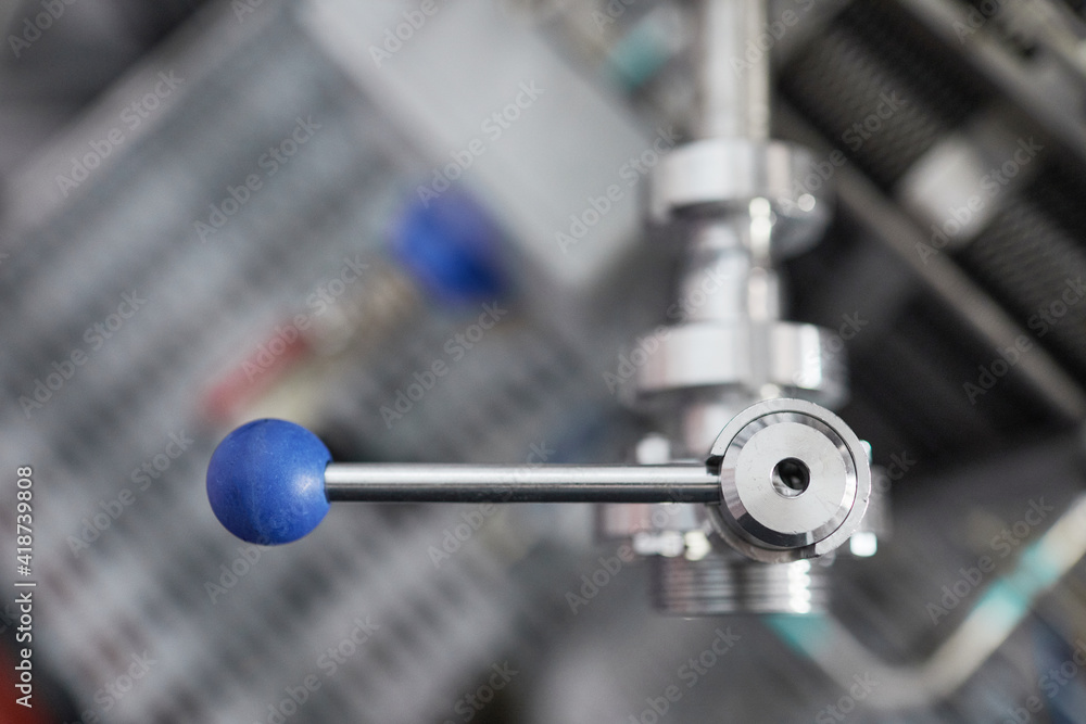 Top view closeup of lock knob opening tap at industrial factory, copy space