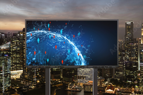 World planet Earth map hologram and social media icons on billboard over night panoramic city view of Singapore, Southeast Asia. Networking and establishing new connections between people. Globe photo
