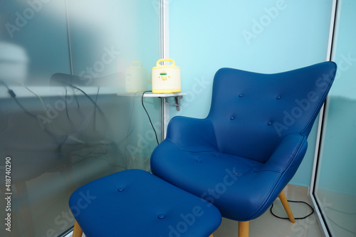 At the room for breast milk taking: chair and milk pump on a table photo