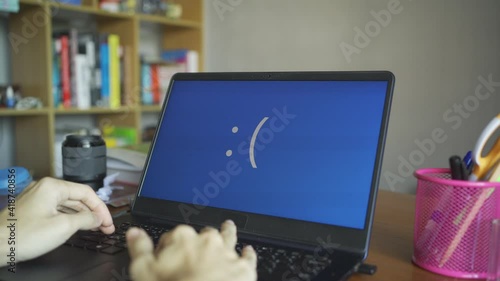 Laptop computer showing its screen with blue screen when it has a system error photo