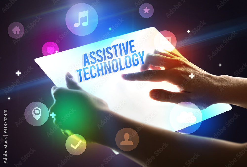 Holding futuristic tablet with ASSISTIVE TECHNOLOGY inscription, new technology concept