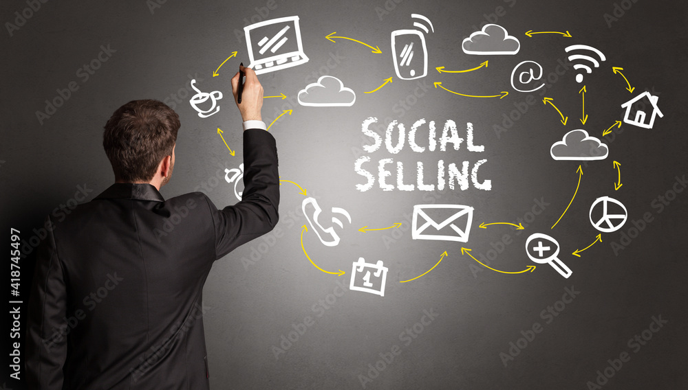 businessman drawing social media icons with SOCIAL SELLING inscription, new media concept businessman drawing social media icons with SOCIAL SELLING inscription, new media concept