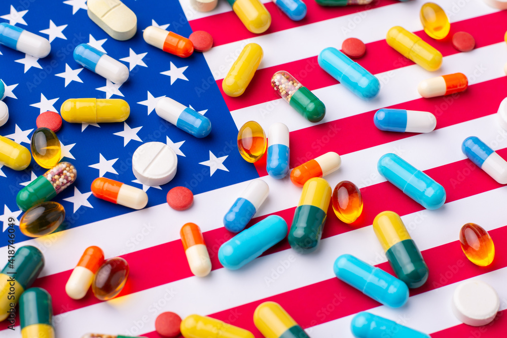 Different pills and tablets on flag of US. Medical system in the United States of America Different pills and tablets on flag of US. Medical system in the United States of America