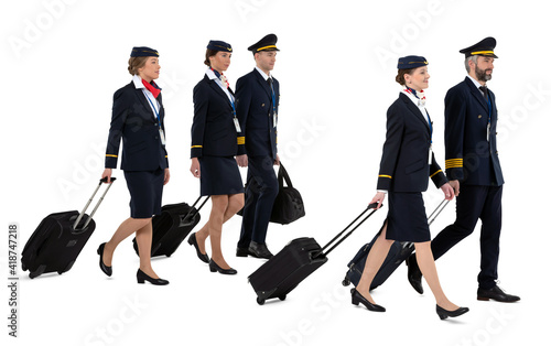 Aircrew walking and pulling their trolley suitcases isolated on white background