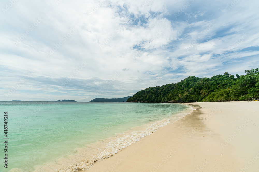 Wave crashing on beautiful beach in Ko Phayam island, Ranong, Thailand.