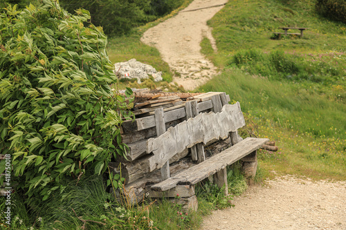 Wooden bench along a mountain pathway, Dolomites, Alta Badia, Italy