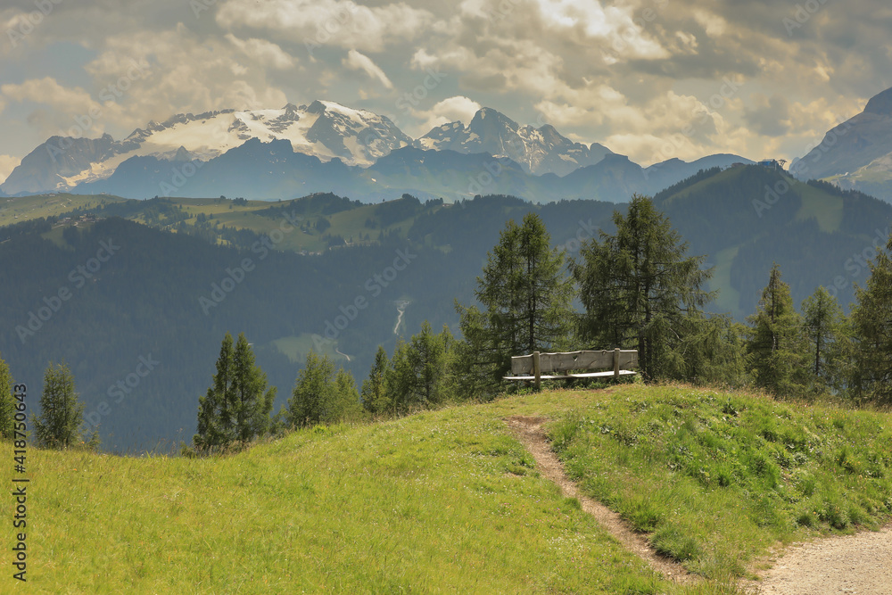 Wooden bench along a mountain pathway, Dolomites, Alta Badia, Italy