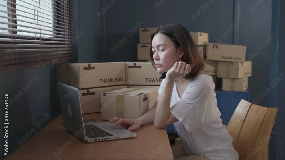 young asian Online store owner woman working and sleeping on desk packing the order for shipping to customer. tired female entrepreneur packaging box for delivery feeling exhausted and fall asleep. young asian Online store owner woman working and sleeping on desk packing the order for shipping to customer. tired female entrepreneur packaging box for delivery feeling exhausted and fall asleep.