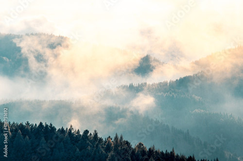 Clouds in mountains in winter during sunset