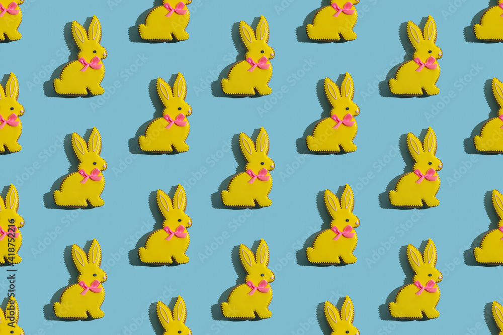 Food banner. Seamless pattern. Cute bunny decor. Conceptual art. Abstract background. Pretty rabbit gingerbread cookies with yellow icing isolated on blue textured.