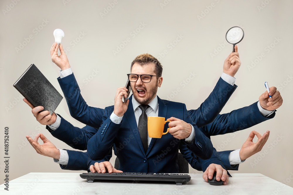 Businessman with many hands in a suit. Works simultaneously with ...