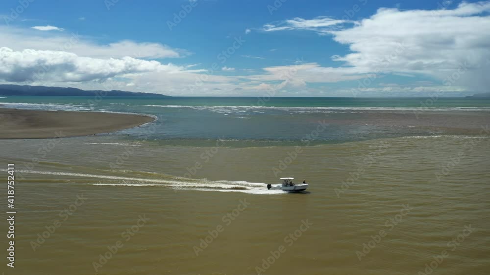Zancudo aerial shot following a boat mouth river pacific ocean Costa Rica Zancudo aerial shot following a boat mouth river pacific ocean Costa Rica