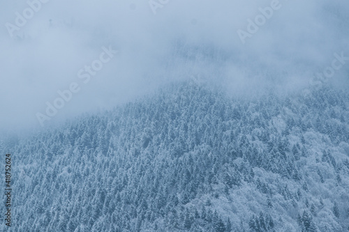 Snowy mountain covered in clouds in winter
