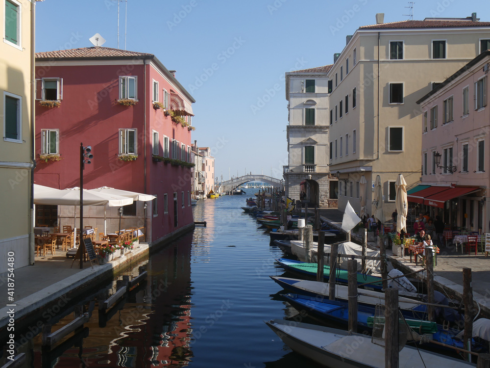 Chioggia, Vena Canal with colorful ancient buildings on both sides and crossed by Vigo Bridge