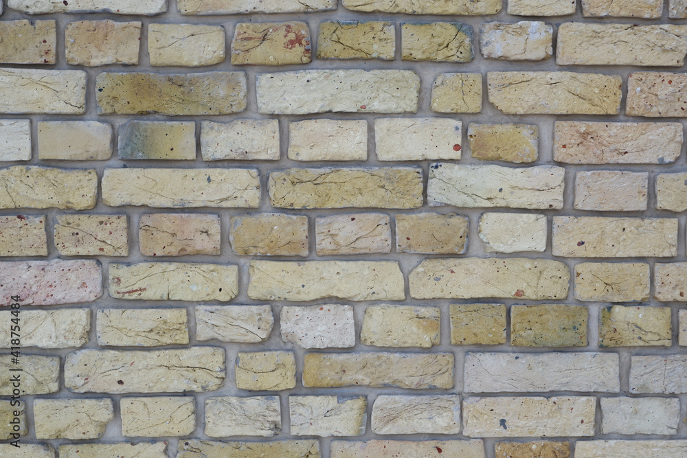 Fototapeta premium Peeled old brick wall. Brick yellow background.