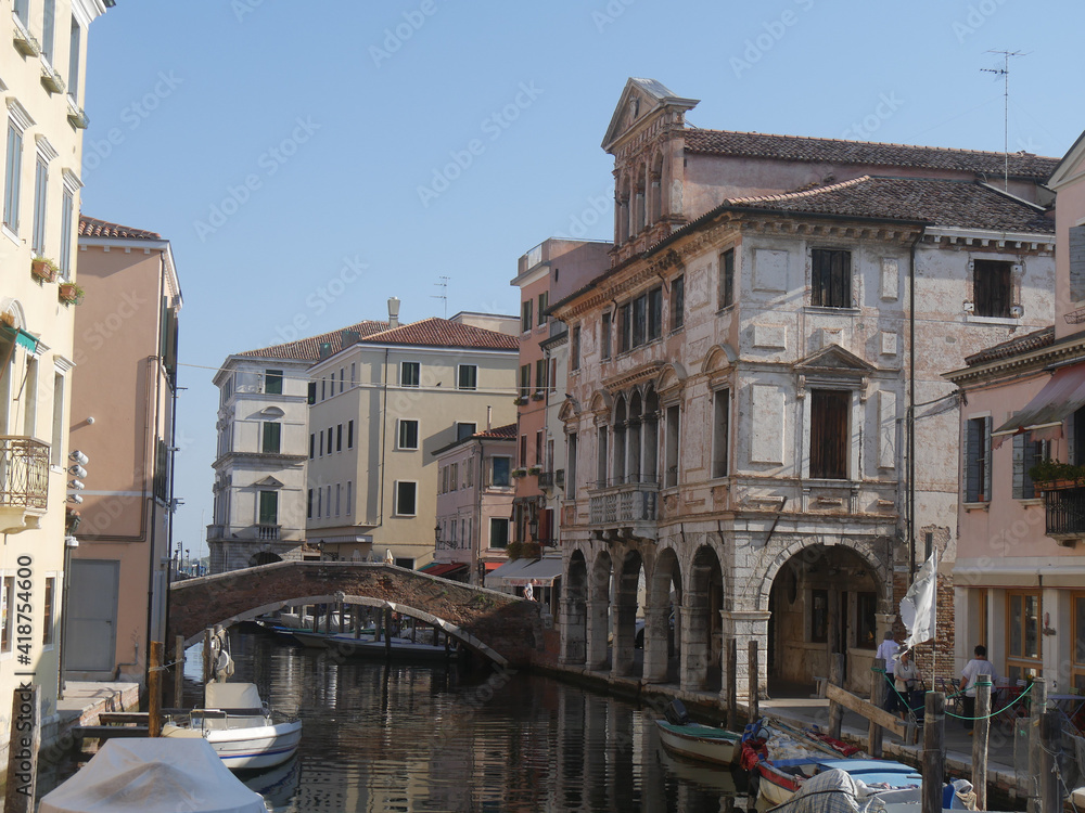 Chioggia, Vena Canal with colorful ancient buildings on both sides and Grassi Palace