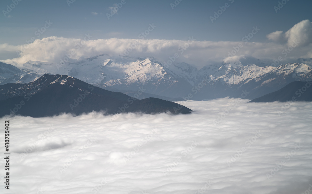 Mountain Range Emerging From The Clouds