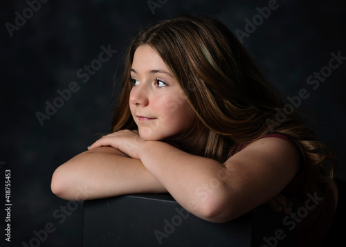 Foto Young tween girl with long hair, low key