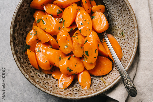 Overhead view of a bowlful of glazed carrots