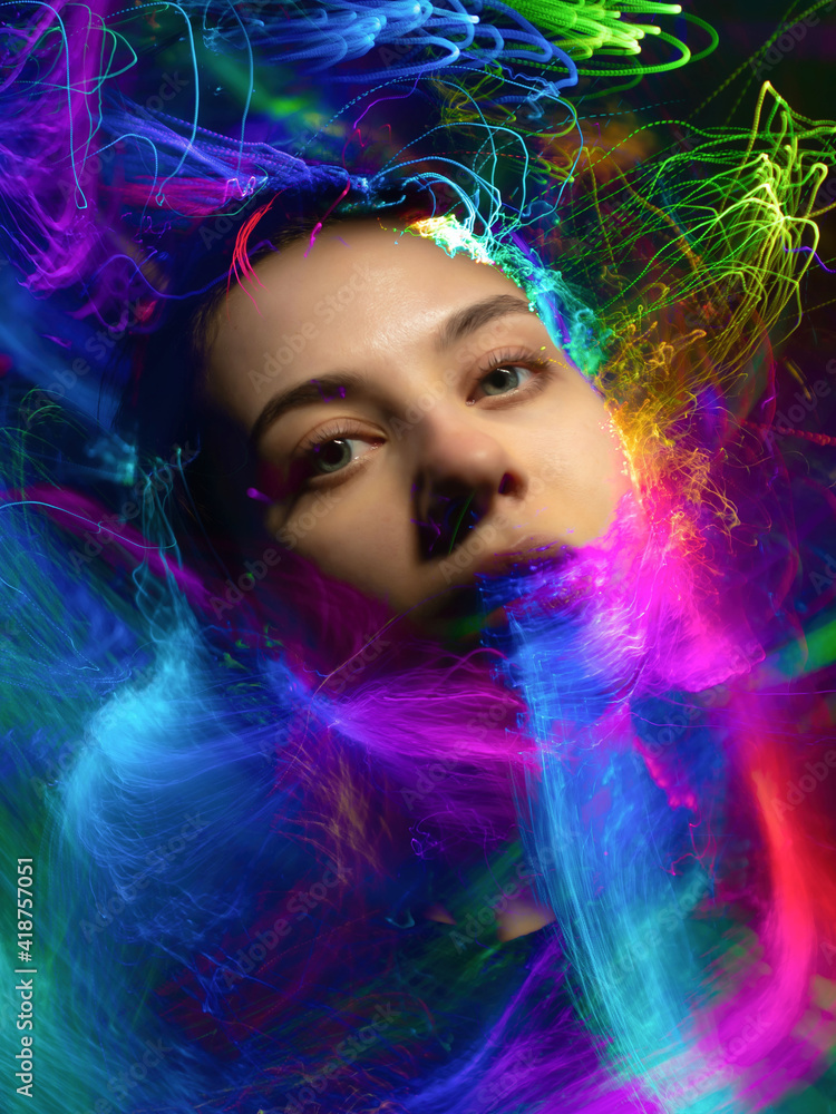 Abstract portrait of a girl in multicolored smoke, light painting photo