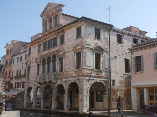 Chioggia, Grassi Palace with baroque facade with balconies and a triangular pediment along Vena Canal