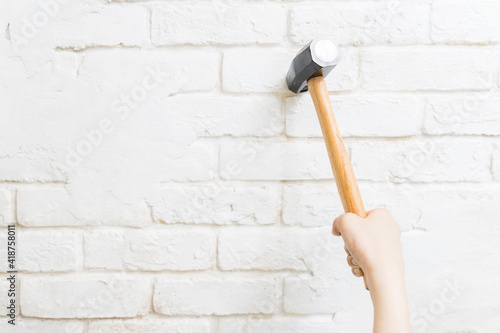 Hammer swung down against the wall