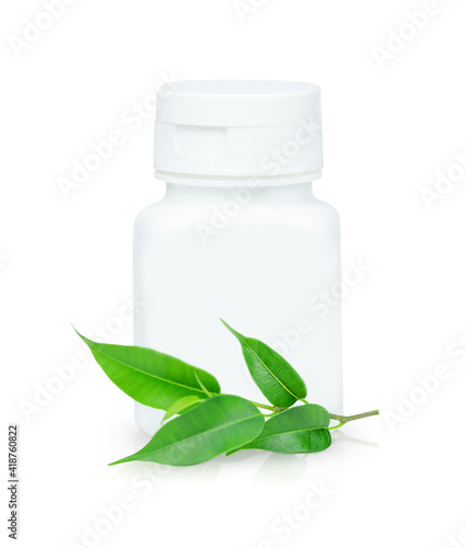 White medicine bottle with a small green twig with leaves isolated on a white background © Julia Anisimova