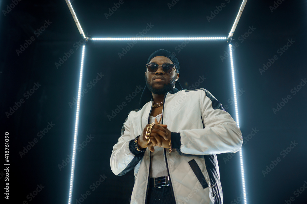Stylish rapper in sunglasses, dark background - obrazy, fototapety, plakaty 
