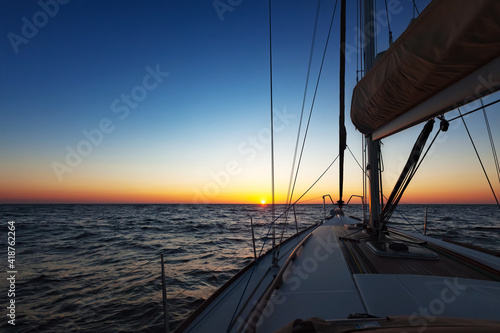 Fototapeta Naklejka Na Ścianę i Meble -  Sailing boat at open sea at sunset