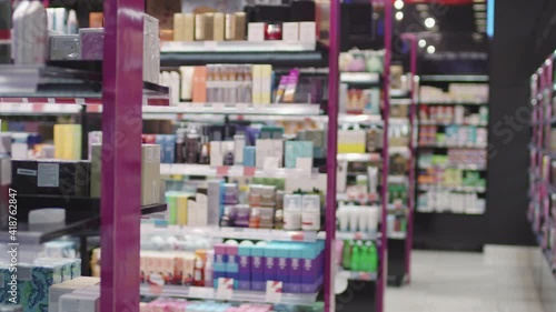 Wallpaper Mural Panning no people overview of stands with cosmetic and skin care products on shelves in big cosmetics store designed in pink colors Torontodigital.ca