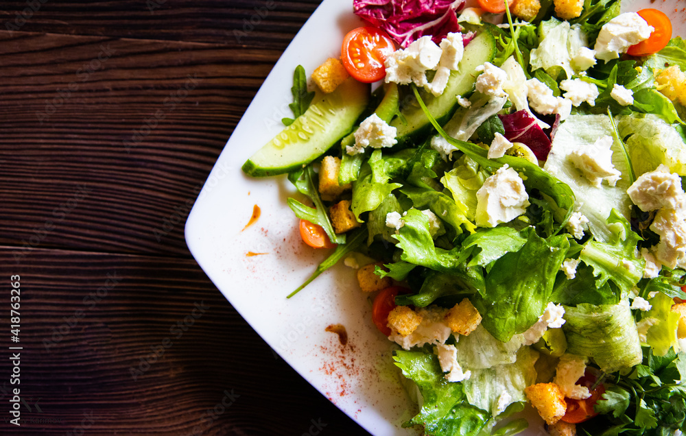 vitamin salad of fresh vegetables on a white plate close-up vitamin salad of fresh vegetables on a white plate close-up