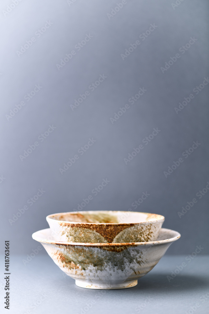 Traditional ceramic bowls on paper background. Copy space. Traditional ceramic bowls on paper background. Copy space.