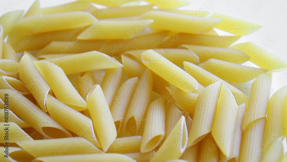 Pasta uncooked, penne dry pasta top view of raw nacaroni, close up Pasta uncooked, penne dry pasta top view of raw nacaroni, close up