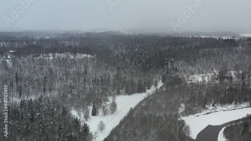 Aerial flight trough snow storm in the forest