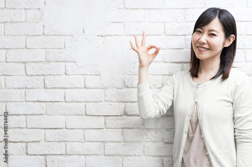 Woman expressing OK sign (gesture)