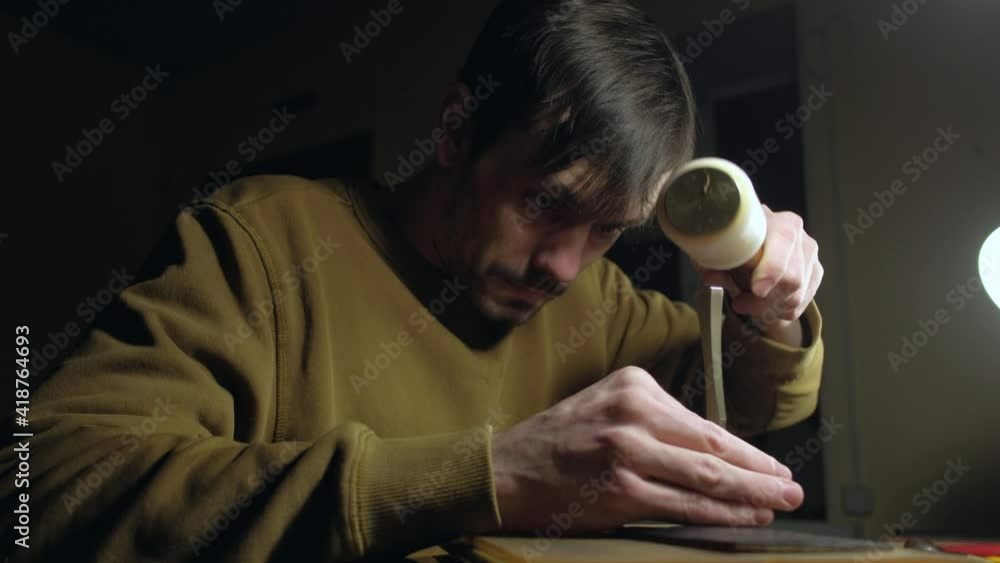 The tanner left handed making holes in leather with puncher tool ...