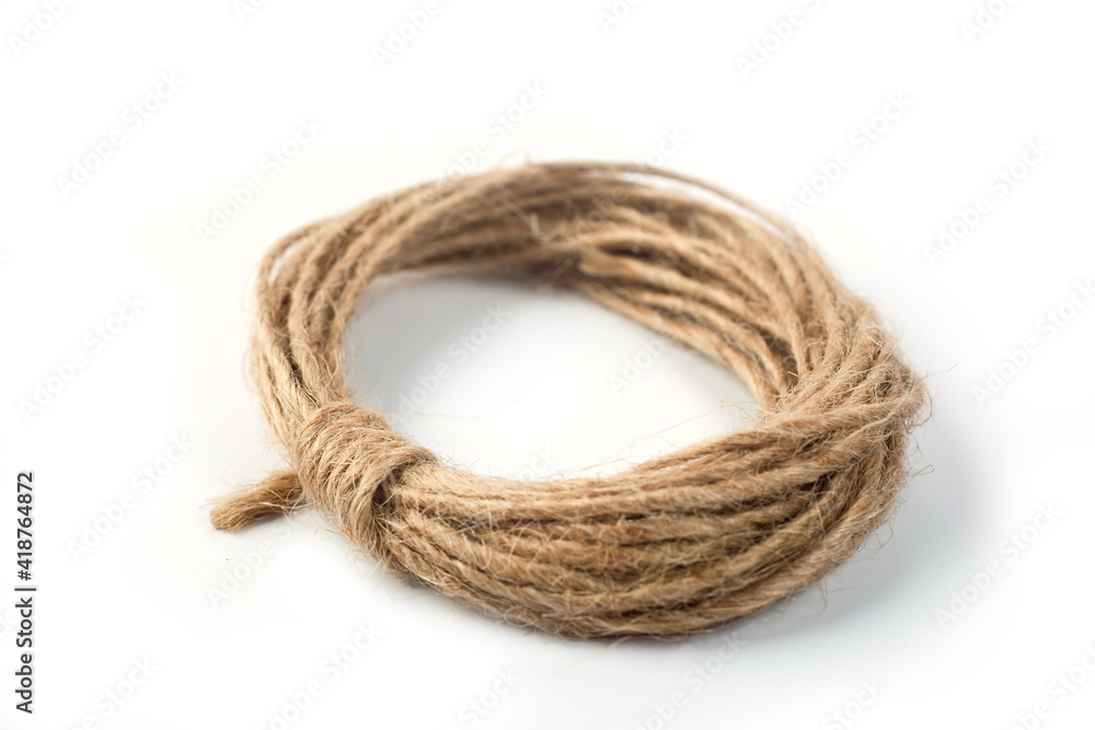 linen rope rolled into ring on white background