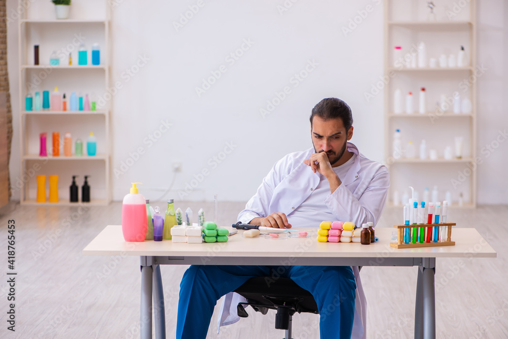 Young male chemist testing soap in the lab Young male chemist testing soap in the lab