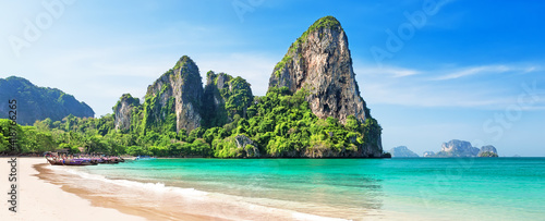 Panorama of beautiful sand Railay beach and thai traditional wooden longtail boat in Krabi province, Thailand. photo