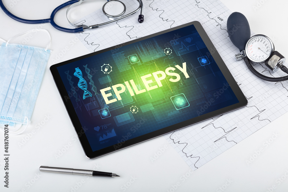 Tablet pc and medical stuff with EPILEPSY inscription, prevention concept Tablet pc and medical stuff with EPILEPSY inscription, prevention concept