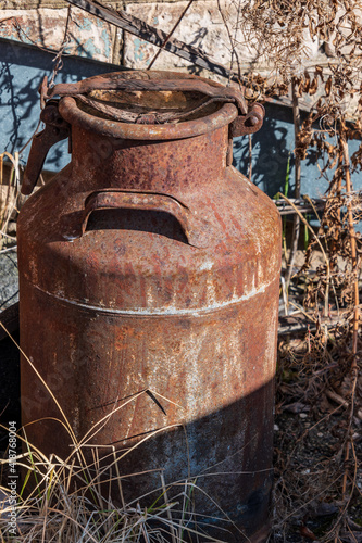 Old rusty metal milk jug.