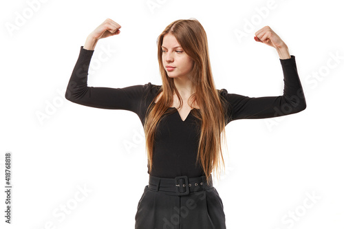 Girl raises arms to show her muscles feels confident in victory, looks strong and independent