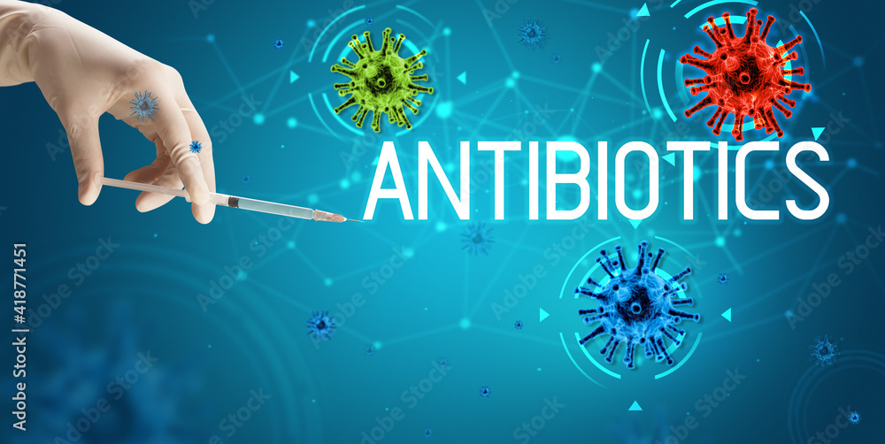 Syringe, medical injection in hand with ANTIBIOTICS inscription, coronavirus vaccine concept