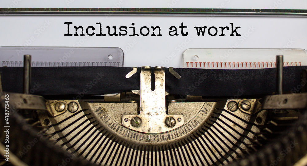 Inclusion at work and belonging symbol. Concept words 'inclusion at work' typed on retro typewriter. Business, inclusion at work and belonging concept. Beautiful background. Inclusion at work and belonging symbol. Concept words 'inclusion at work' typed on retro typewriter. Business, inclusion at work and belonging concept. Beautiful background.
