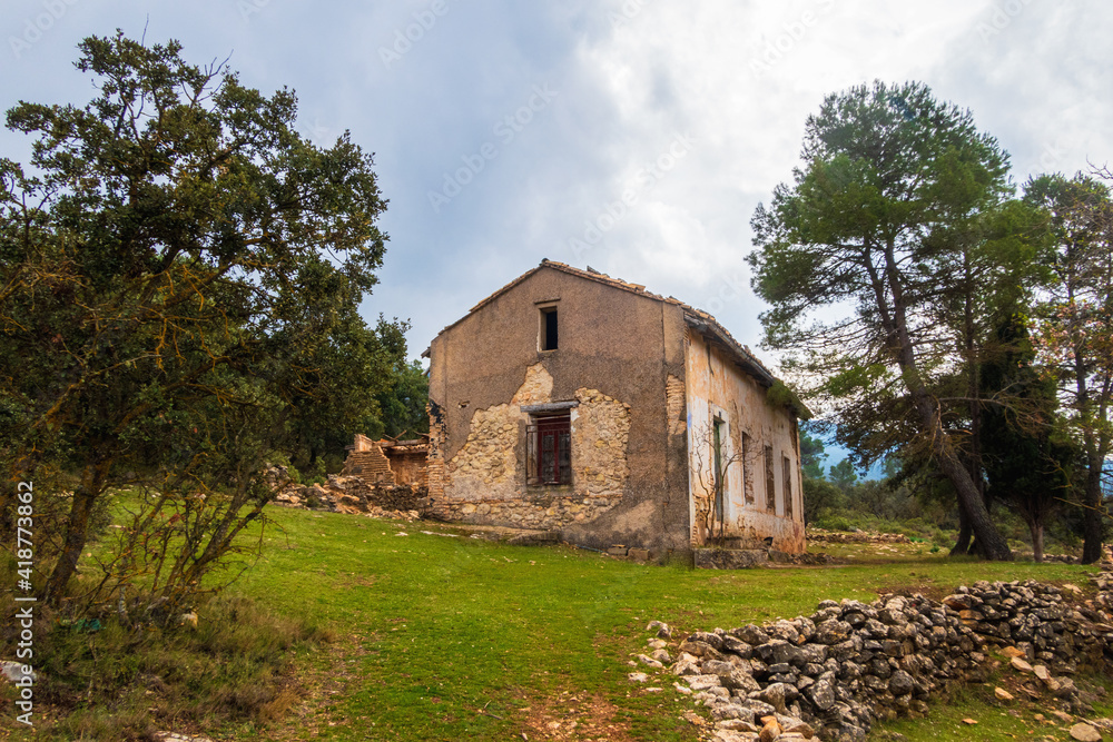 abandoned country house in a Mediterranean forest, on a cloudy day. abandoned country house in a Mediterranean forest, on a cloudy day.