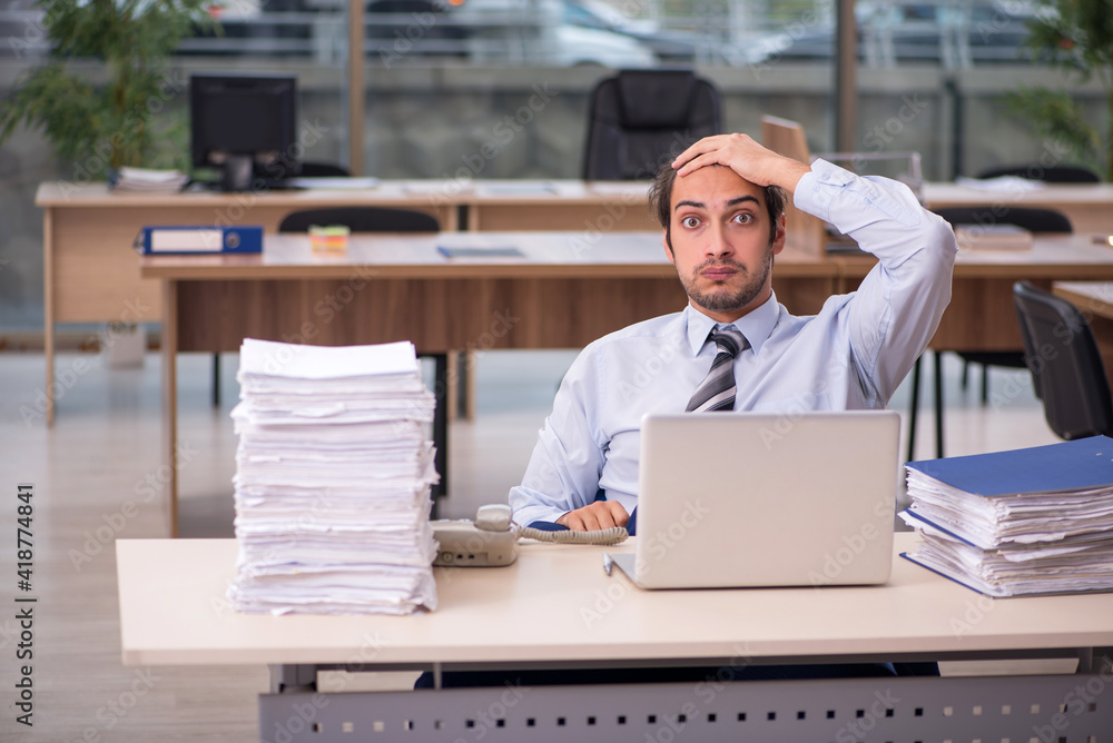 Young male employee working in the office Young male employee working in the office