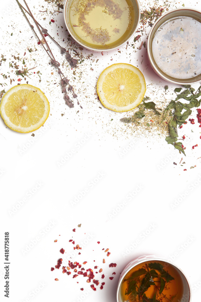 Herbal tea, top view with copy spce. Dry herbs, lemon slices and tea cups on white. Herbs in bulk, zero waste and eco-friendly lifestyle, herbal medicine concept. Herbal tea, top view with copy spce. Dry herbs, lemon slices and tea cups on white. Herbs in bulk, zero waste and eco-friendly lifestyle, herbal medicine concept.