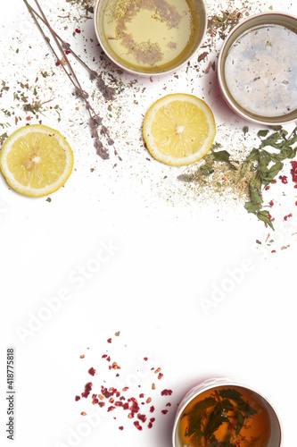 Herbal tea, top view with copy spce. Dry herbs, lemon slices and tea cups on white. Herbs in bulk, zero waste and eco-friendly lifestyle, herbal medicine concept.	