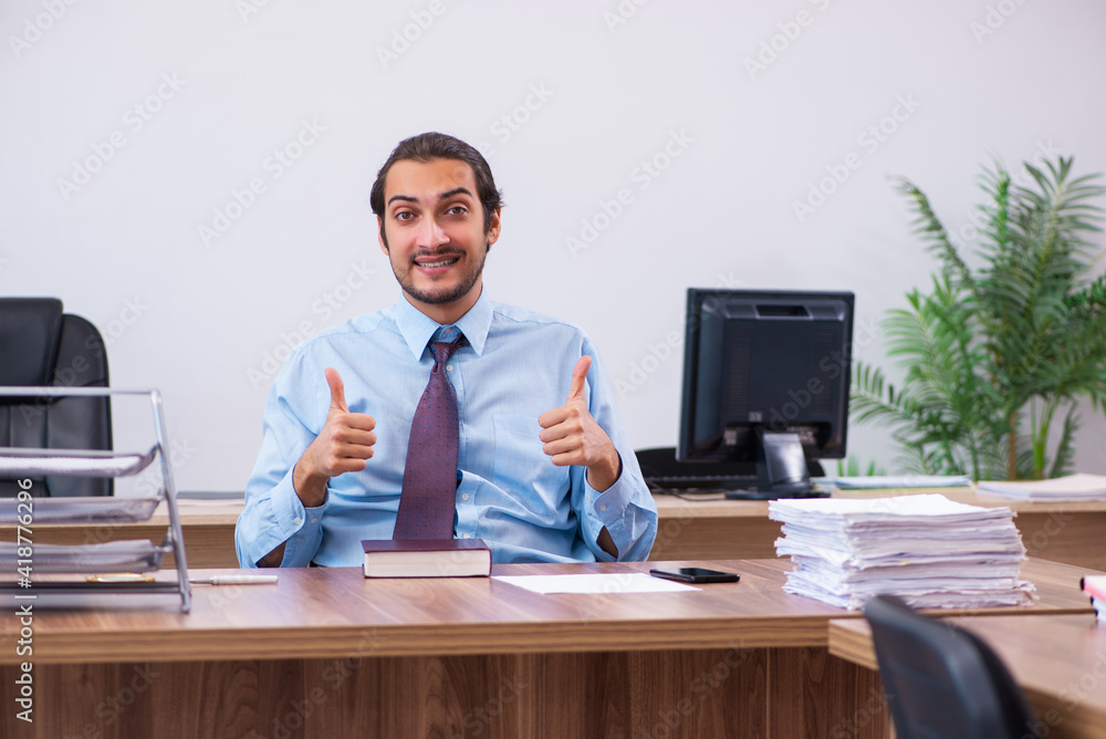 Young male employee working in the office Young male employee working in the office